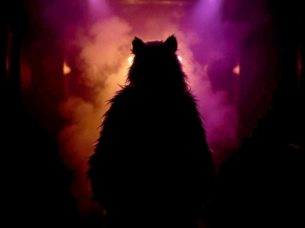 Deliberately vague silhouette of a furry in a dimly lit, upscale venue